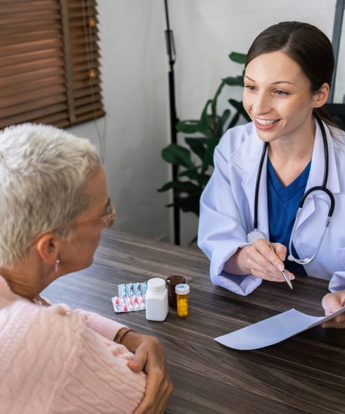 Caucasian Female doctor are advice medication and vitamin daily to caucasian elderly patient.